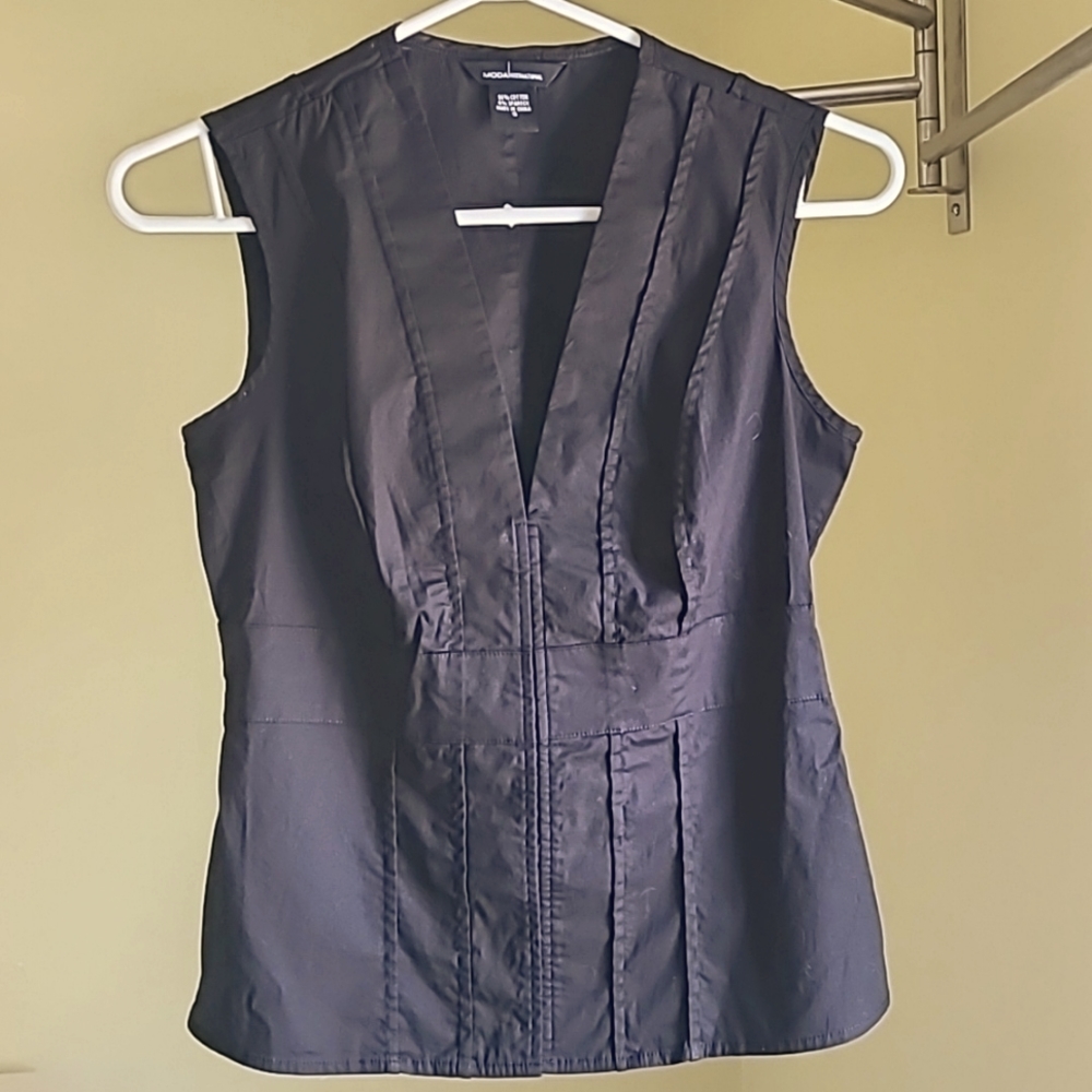 Black sleeveless blouse with snap closures. Size small